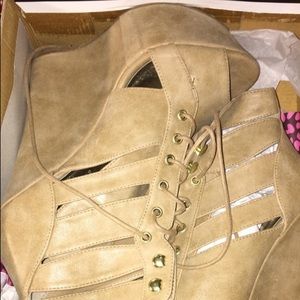Pair of beige open-toe leather wedge shoes in box